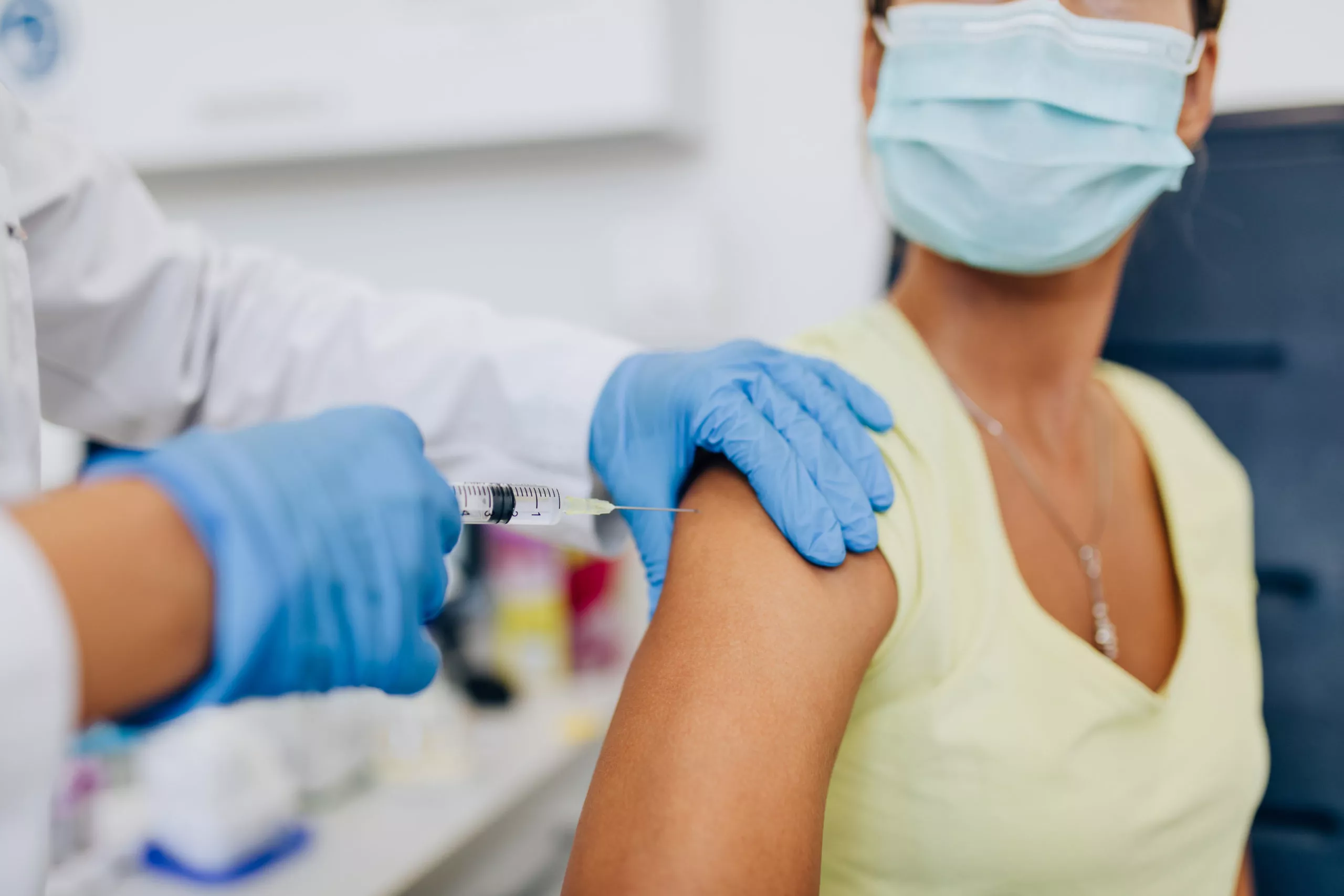 Female,Doctor,Or,Nurse,Giving,Shot,Or,Vaccine,To,A